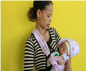 A woman carrying a child