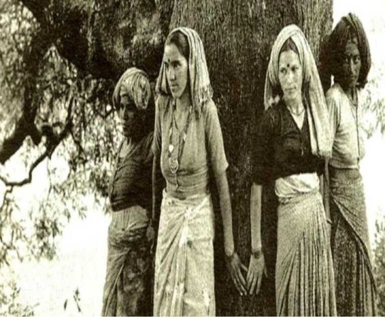 Ladies standing around a tree